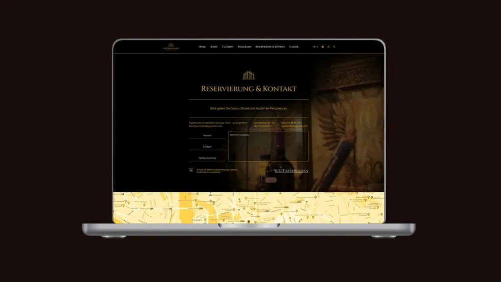 Laptop showing the “Reservation & contact” page, with the golden map detail below it
