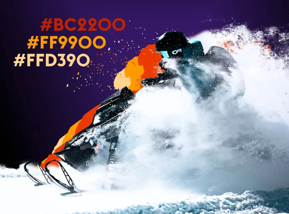 The brand's orange accent values next to a snowmobile in a cloud of snow