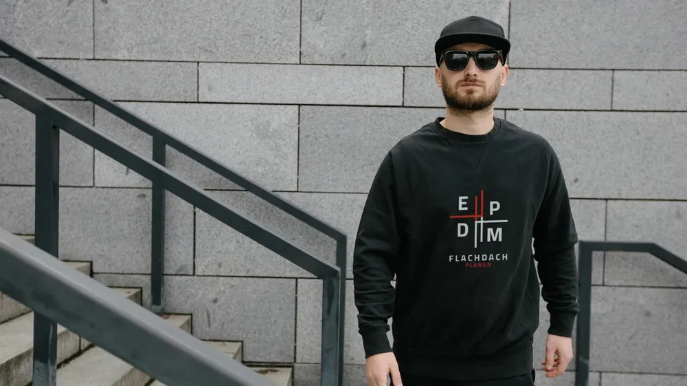 A black sweater with the EPDM logo on the chest