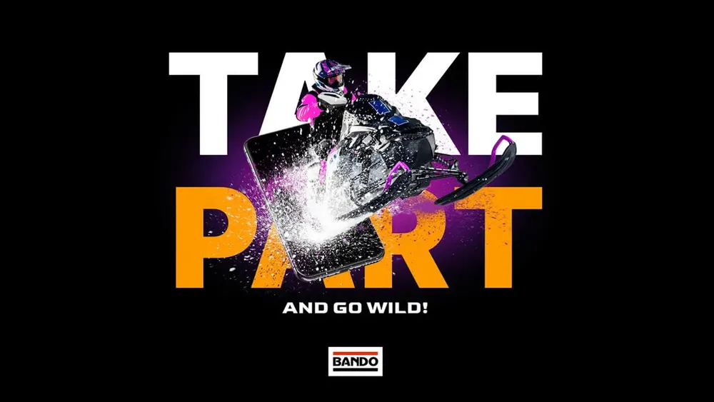 Ad “Take part and go wild” with a snowmobile in a spray of snow