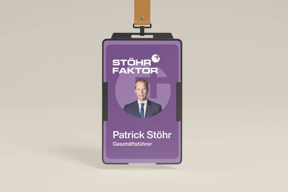 Employee ID card on a lanyard with a photo of Patrick Stöhr