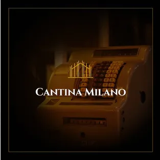 An old cash register, darkened, with the logo on top