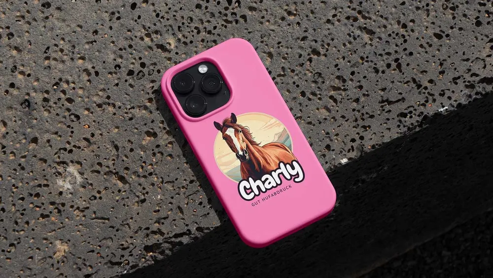 Pink phone case with the “Charly” design on dark asphalt