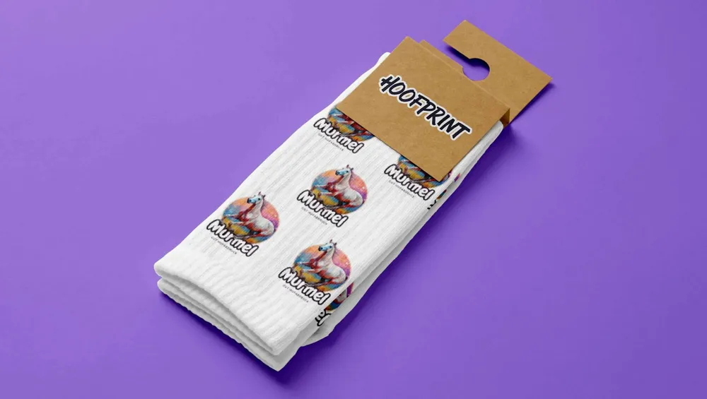 White socks with small horse designs in their kraft paper band