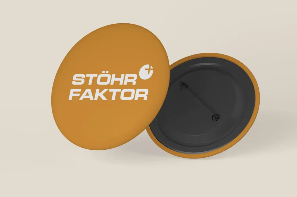 Two orange pin badges with the wordmark