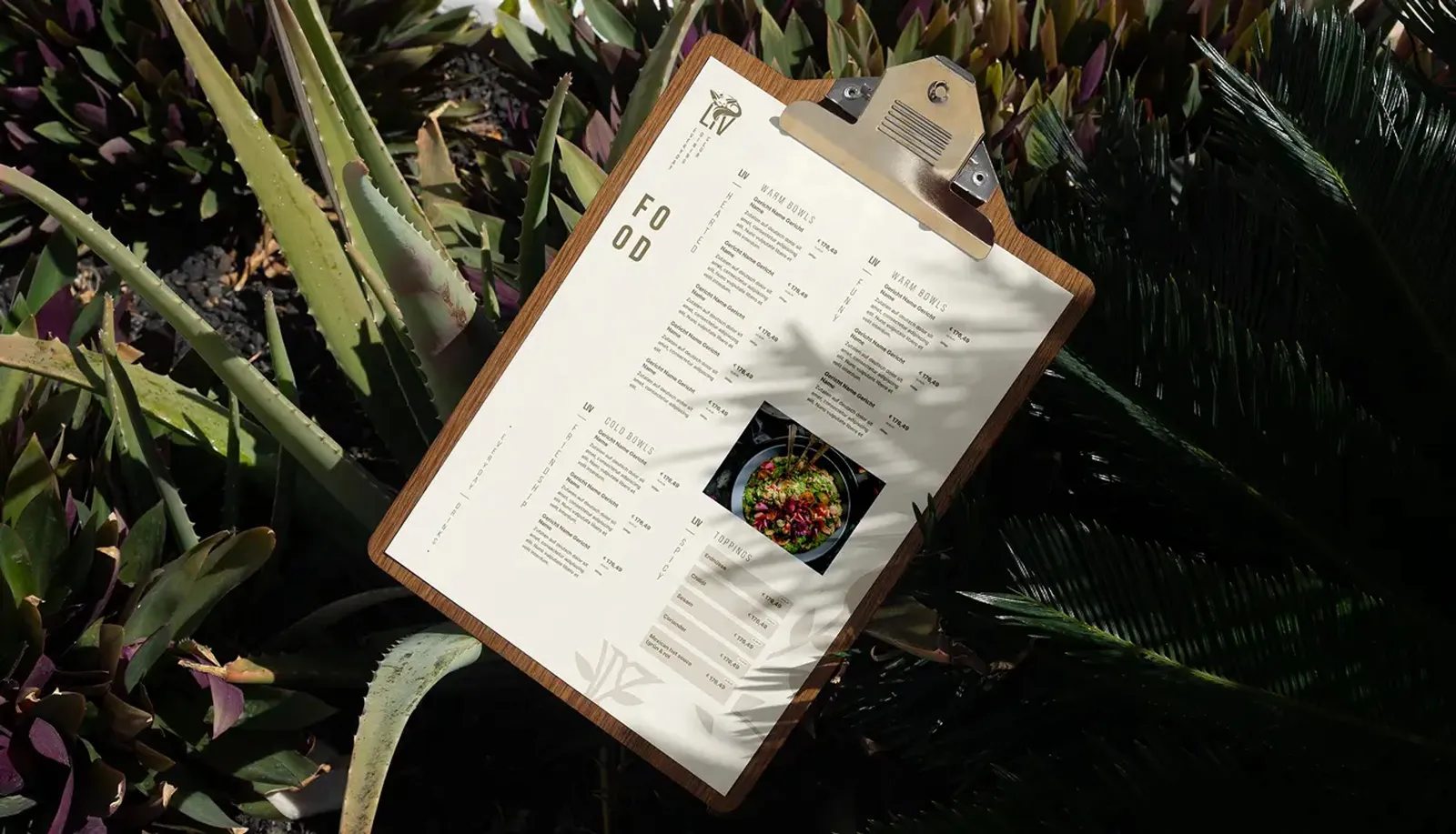 Food menu on a clipboard, surrounded by tropical plants