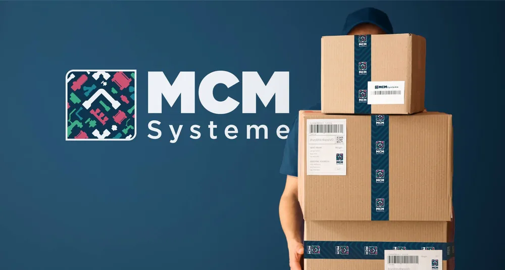 An employee carries stacked parcels sealed with MCM tape, the logo beside them