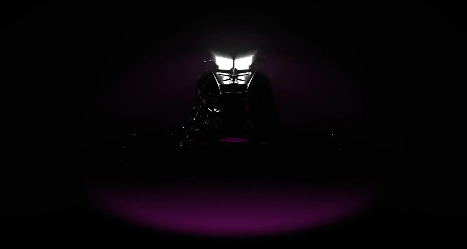 A snowmobile turns out of the darkness into the frame in the beam of the headlights