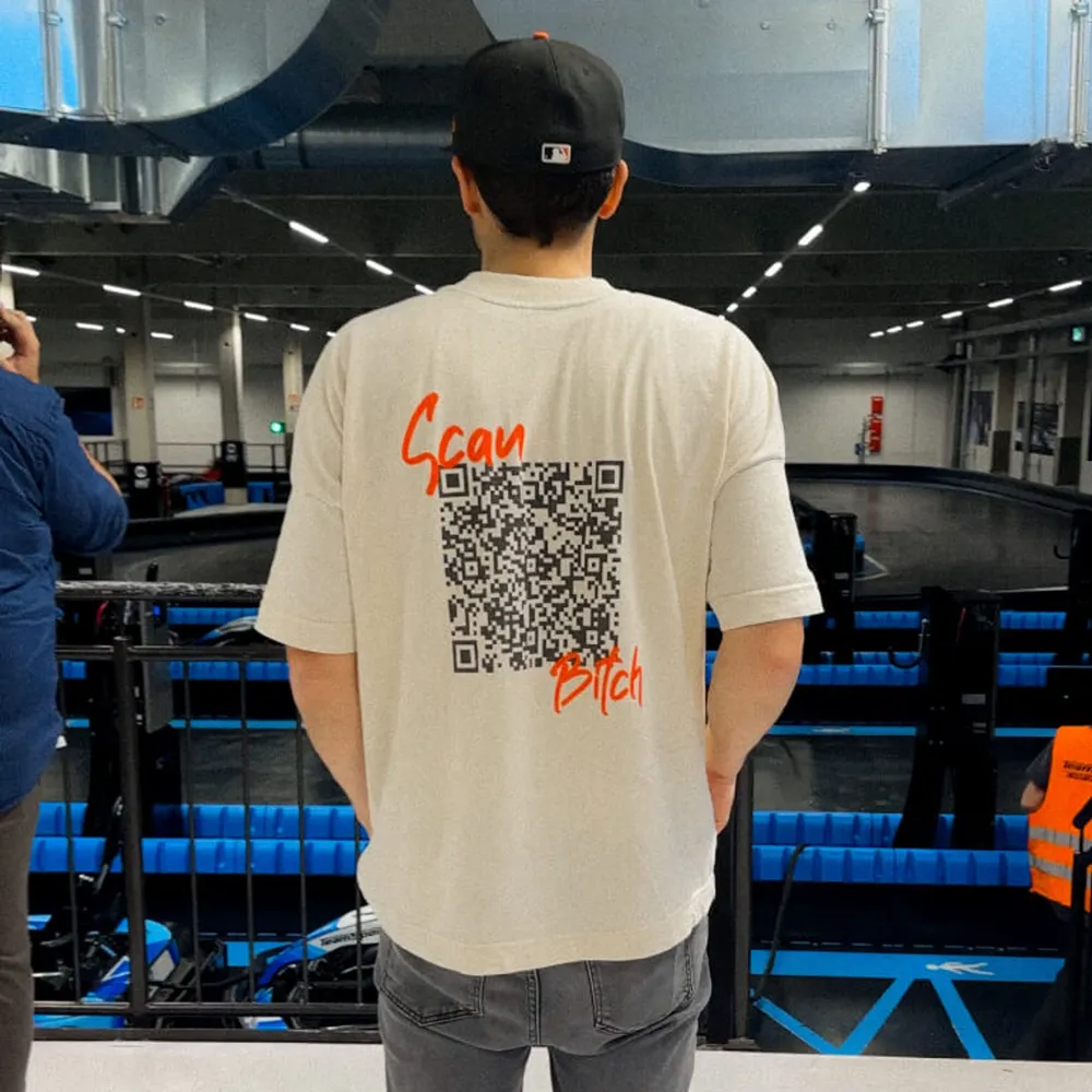 A participant seen from behind in a shirt with a large QR code on the back