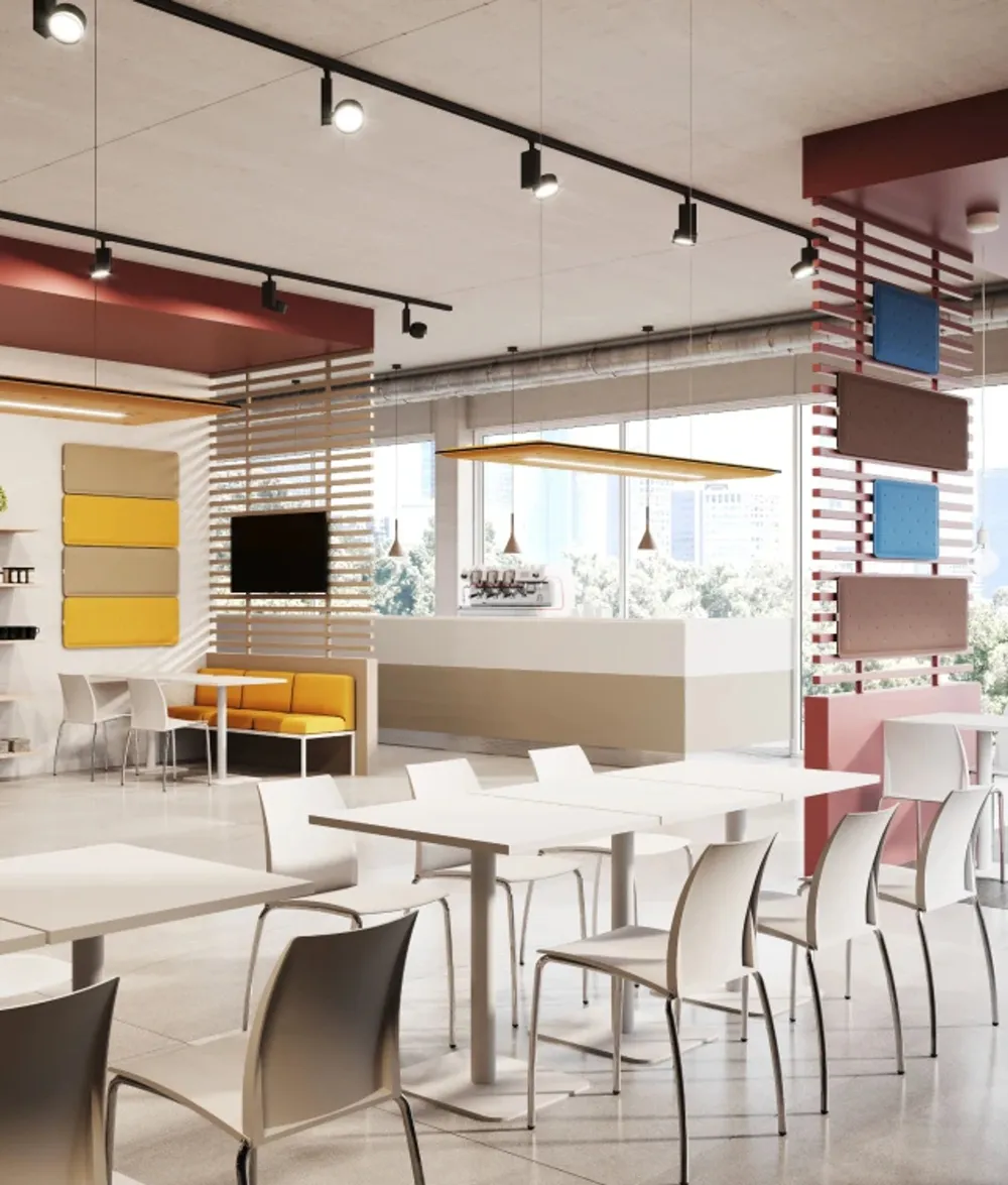 An open-plan office with yellow acoustic elements on the wall and desk
