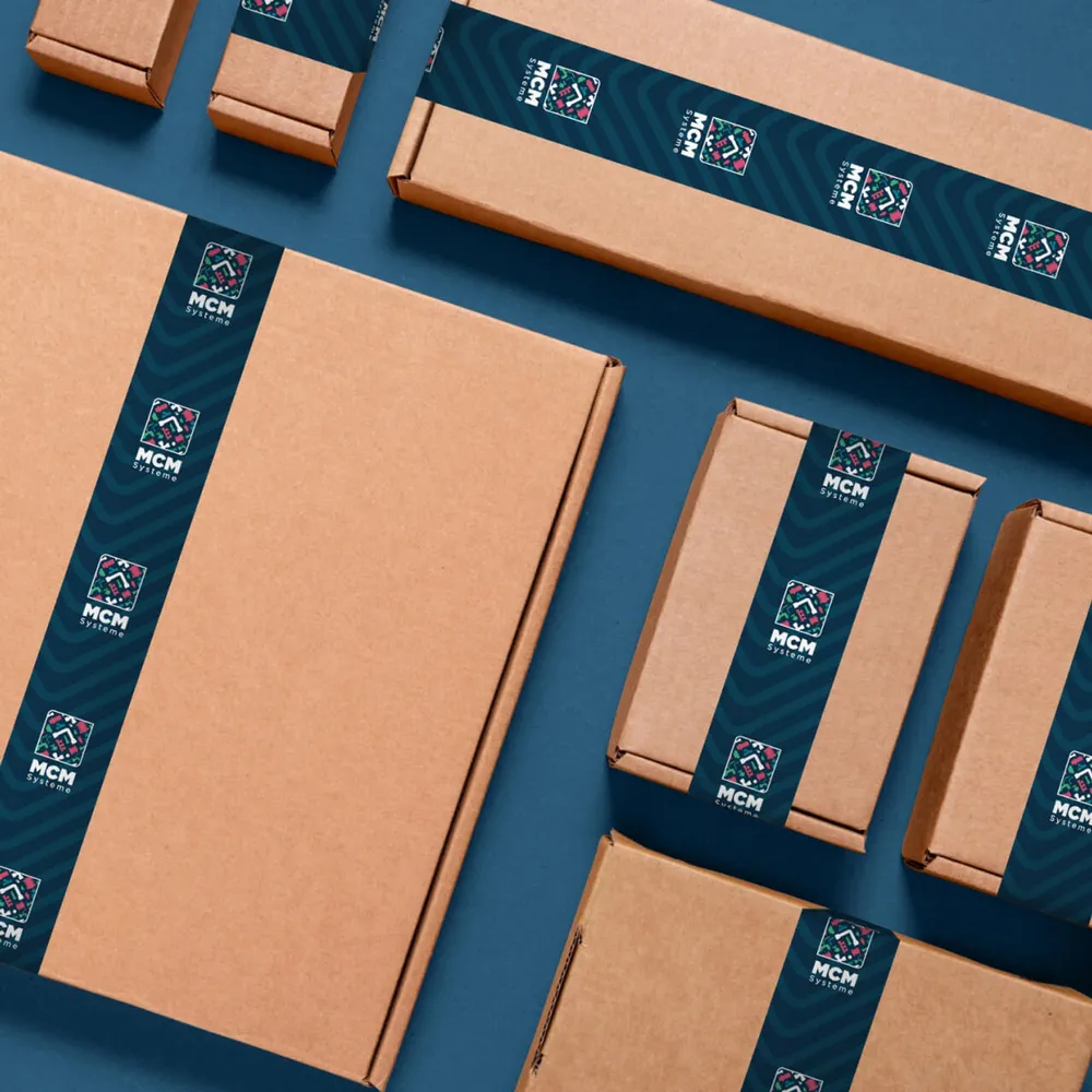 Cardboard boxes with patterned tape and logo, photographed from above