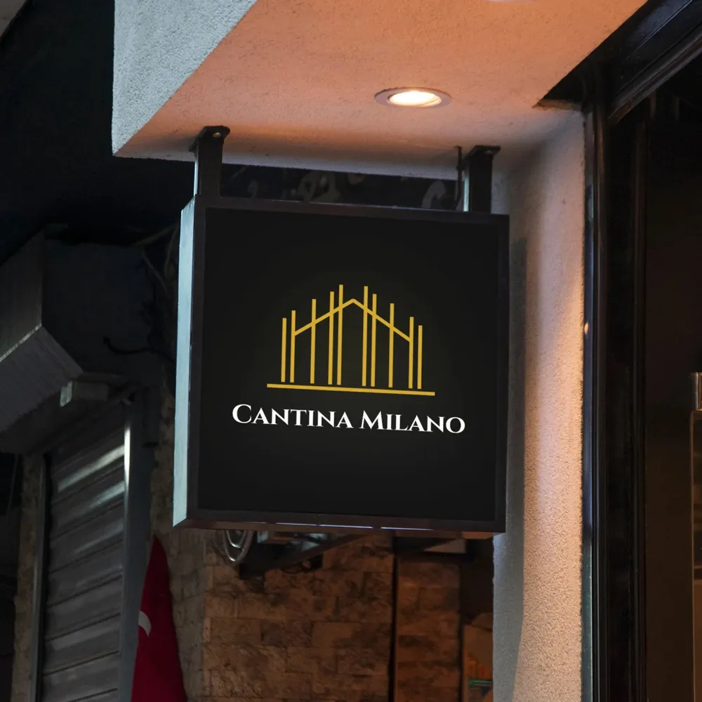 The illuminated projecting sign with emblem and wordmark above the entrance