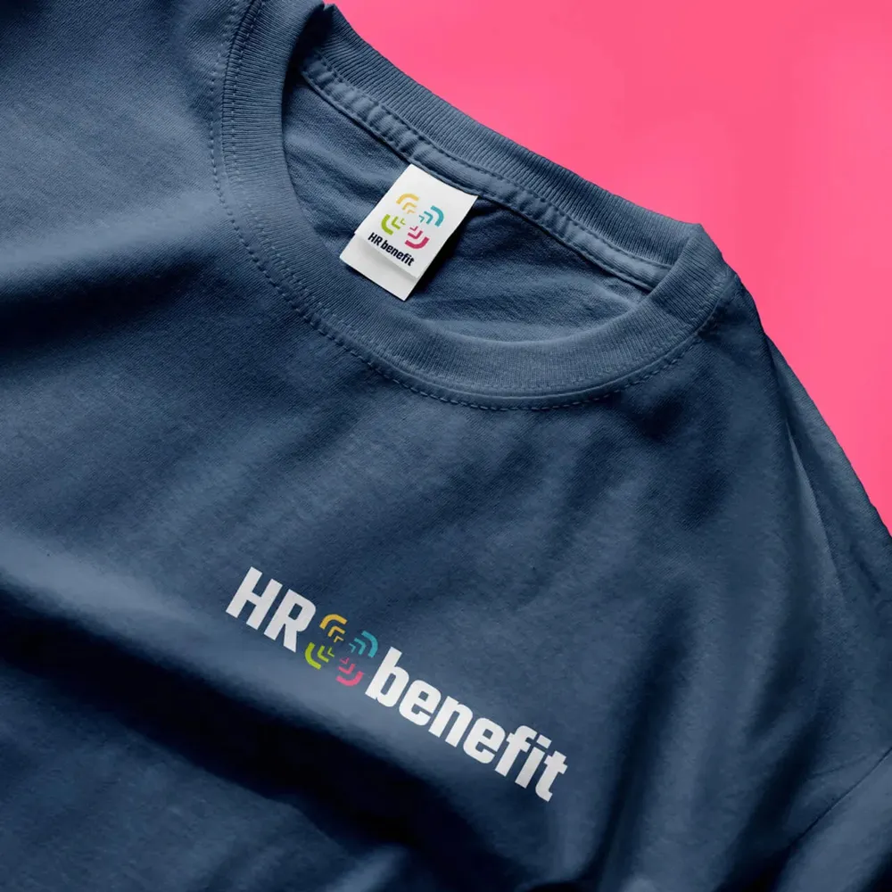 Dark blue T-shirt with the wordmark across the chest, close-up on pink