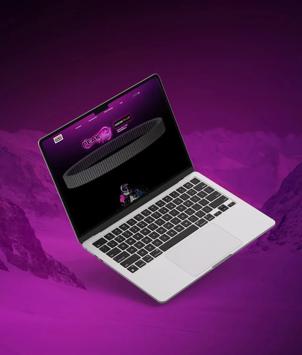 Laptop showing the landing page against a magenta background